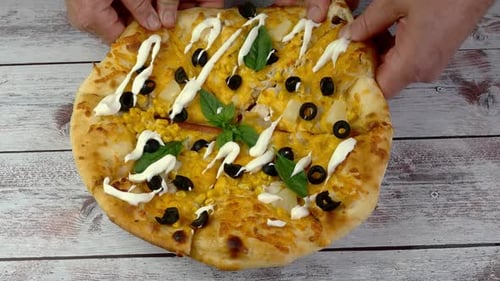 Fresh Pizza Sliced and Plated on Wood Surface
