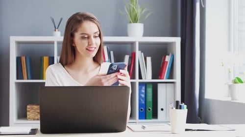 Young Woman Works at Home Office Using Computer.