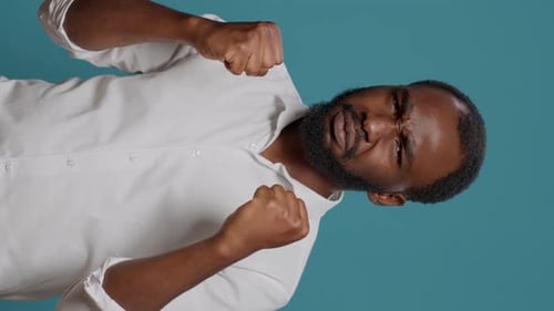 Furious Man Clenches Fists in Anger