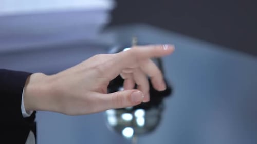 Hand Taps Reception Bell on Office Desk