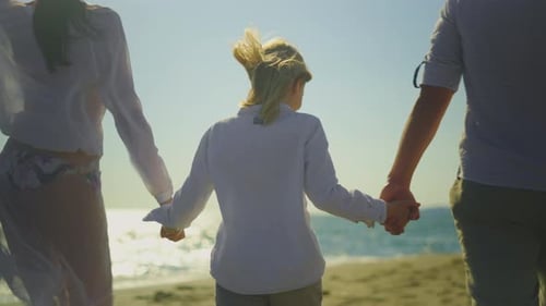Family with one child walking on beach