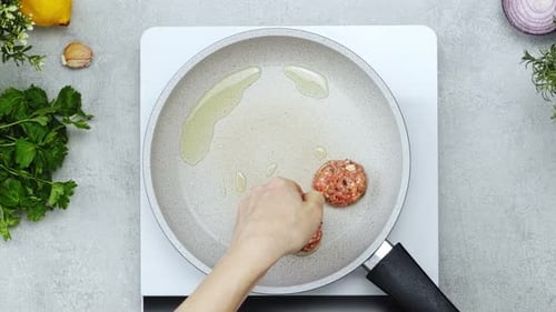 Unrecognizable person frying meatballs for lunch