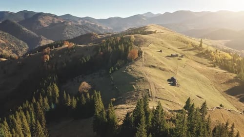 Epic Aerial Flight Over Sunset Mountain Peak with Pine Tree Forest Yellow Autumn Meadows Landscape