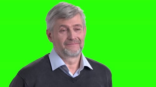 Mature Man Smiling Slightly on Green Screen