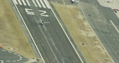 Drone aerial of sunlight pouring through clouds onto green hills, overcast day