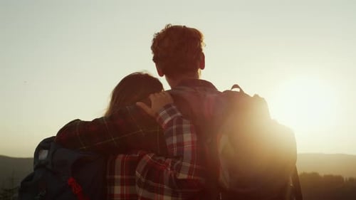 Loving Couple Embracing in the Mountains at Sunset