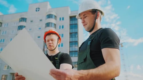 An Builders Are Studying Construction Plan and Analyze Are Building Construction.