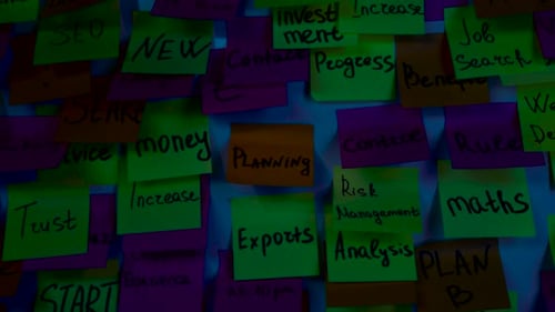 Stickers with Inscriptions Planning, on a Board in a Dark Room
