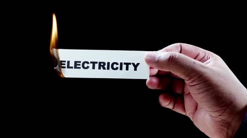 Hand Burns Card with the Word Electricity Written