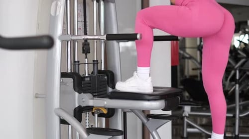 Trainer Girl Doing Leg Muscle Workout in Gym