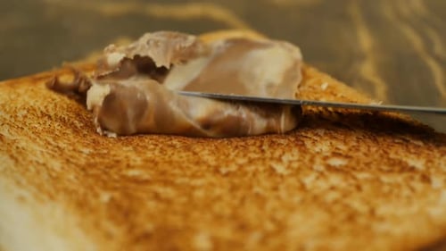 Chocolate Spread Spreading on Toast with a Knife