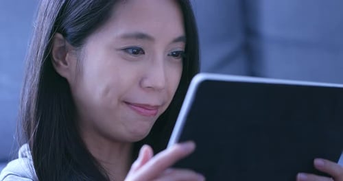 Woman Smiling Using Tablet Device Close Up