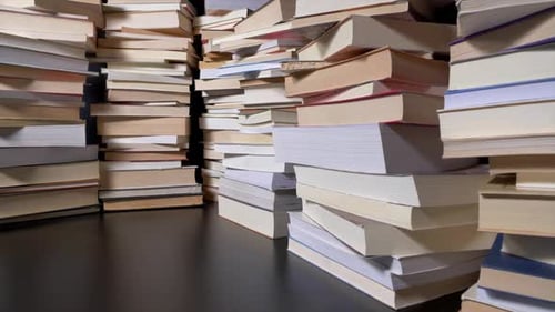 Stacks of books on dark surface