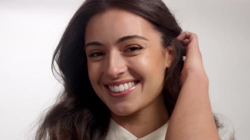Young Brunette Woman Alone in Studio Portrait. Smiling Happy Woman
