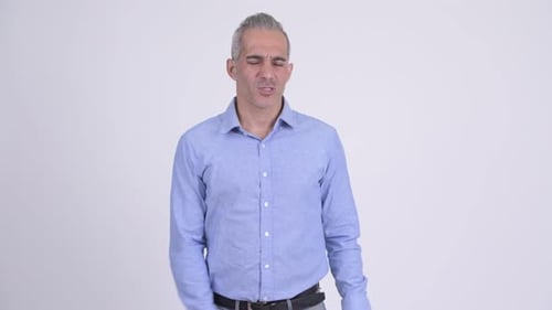 Angry Persian Businessman Giving Thumbs Down Against White Background