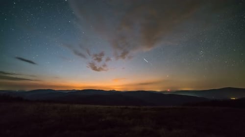 Starry Night Time-Lapse Over Mountainous Terrain