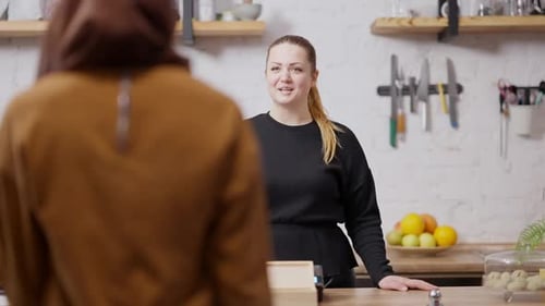 Portrait of Positive Professional Waitress Greeting Client in Cafeteria