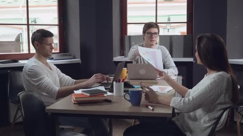 Office Workers Share Ideas and Collaborate at Table