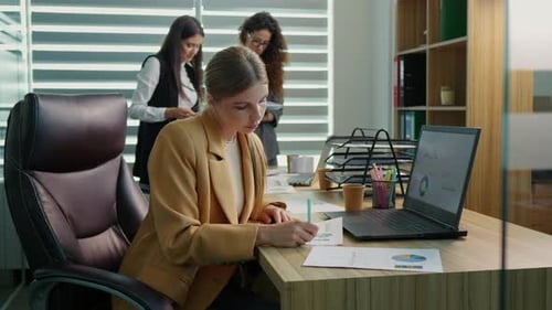 Young Woman Analyzing Data in Modern Office