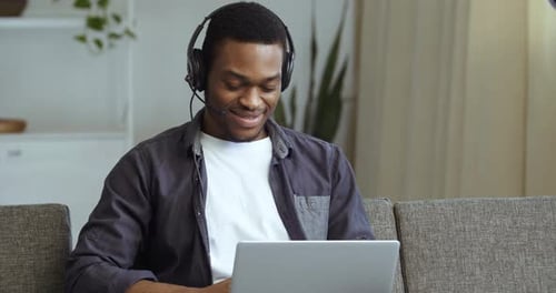 Smiling Man Working on Laptop From Home