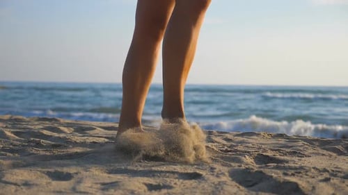 Woman Walking Barefoot on Sandy Beach