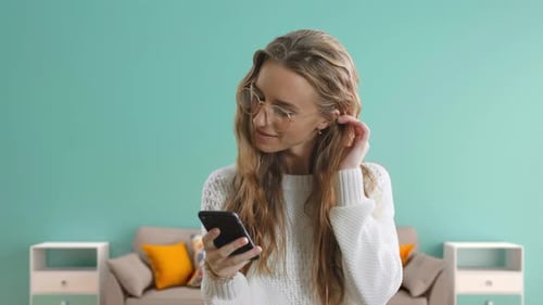 Woman Using Smartphone Indoors in Modern Home