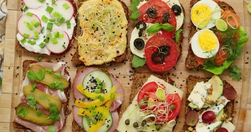Variety of Delicious Open Sandwiches on Cutting Board