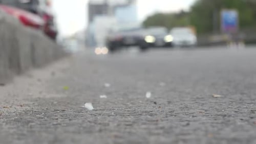 Cars Driving on City Road at Ground Level