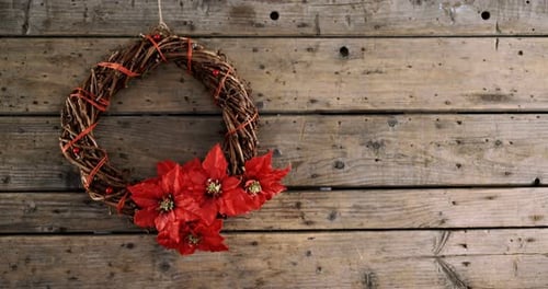 Festive Christmas Wreath with Red Flowers