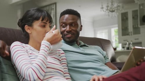 Couple Relaxing Together on Couch Using a Tablet