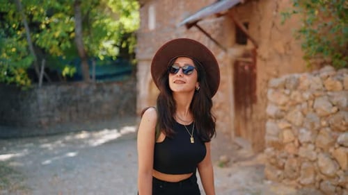 Woman Walking on Stone Path on Sunny Day
