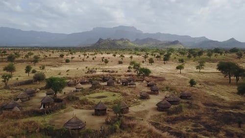 Aerial above an authentic Village With homes made from wood and straw in Uganda, East Africa