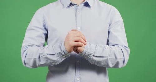 Man Wringing Hands Together on Green Screen