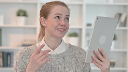 Woman Holding Tablet Having Video Call Indoors