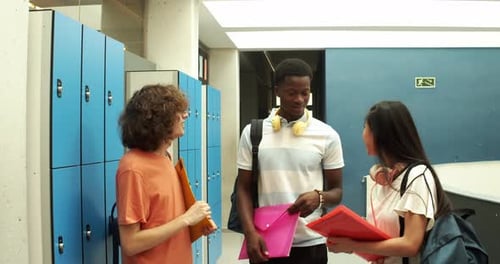 Happy Students Chatting in School Hallway