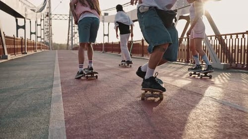 Closeup of the Leg of a Young Man Performing Tricks on a Skateboard