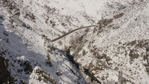Mountain Road Winding Through Snowy Winter Landscape