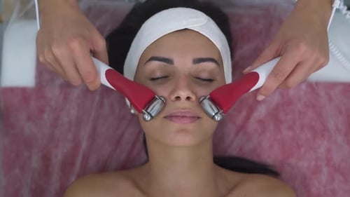 Woman Receiving Facial Treatment at Spa Clinic