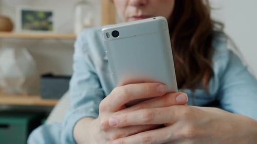 Woman Using Smartphone Device Indoors