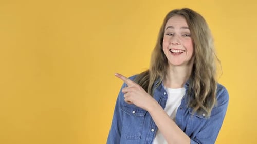 Woman Points to the Left and Smiles
