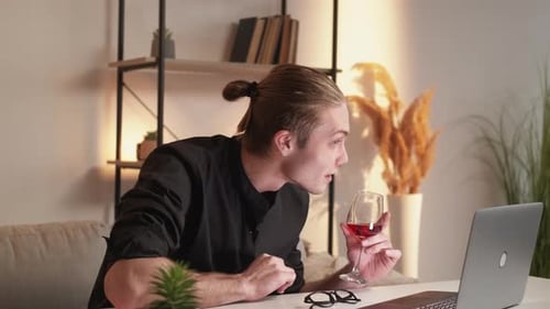 Young Adult Enjoying Wine on Video Call