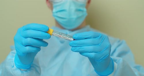 COVID-19 Positive Blood Test Held by Healthcare Worker