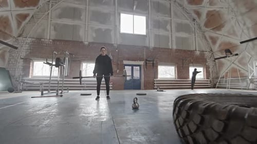 Female Cross Training Athlete Raising Heavy Barbell