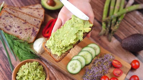 Preparing Delicious Avocado Toast with Fresh Vegetables