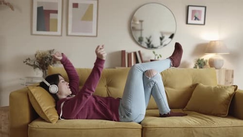 Woman Listening to Music and Relaxing on Couch