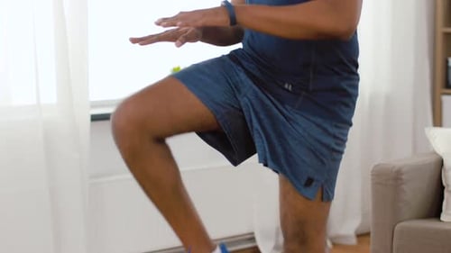 Man Does High Knees in Living Room