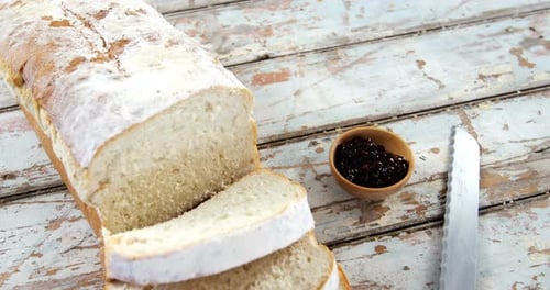 Slices of bread with jam and knife