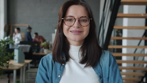Portrait of Beautiful Young Lady Smiling Looking at Camera Standing in Modern Office