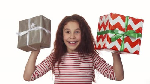 Happy Girl Holding Two Christmas Gifts in Her Hands