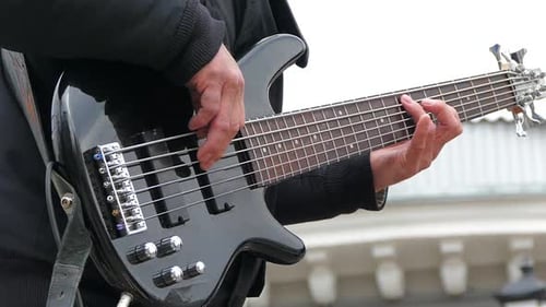 Man Playing Electric Guitar Strings
